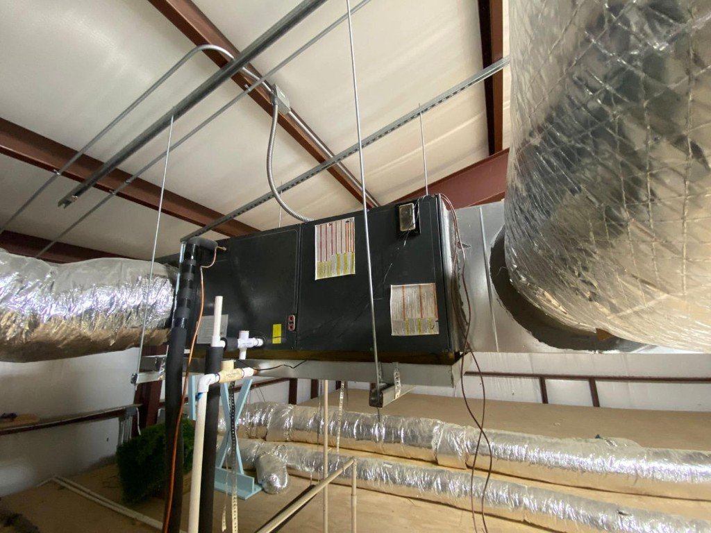Commercial air handler with insulated ductwork installed in a warehouse ceiling