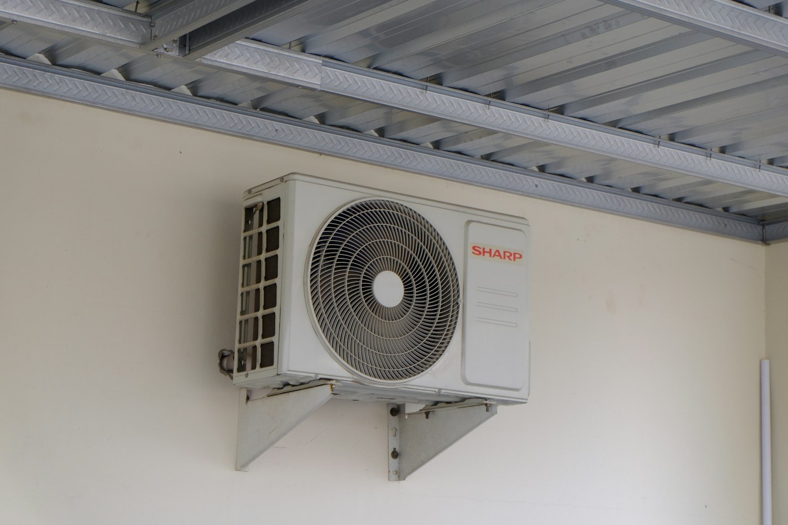 Ductless mini-split outdoor unit mounted on a residential wall