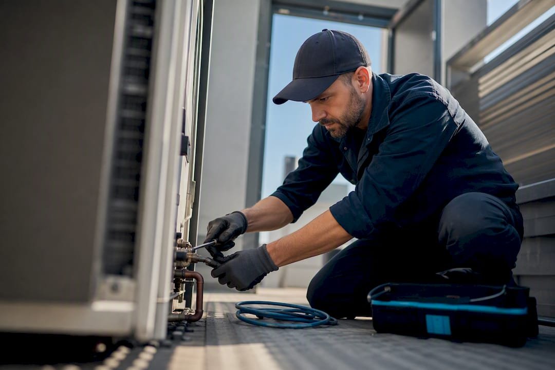 Technician performing scheduled HVAC maintenance